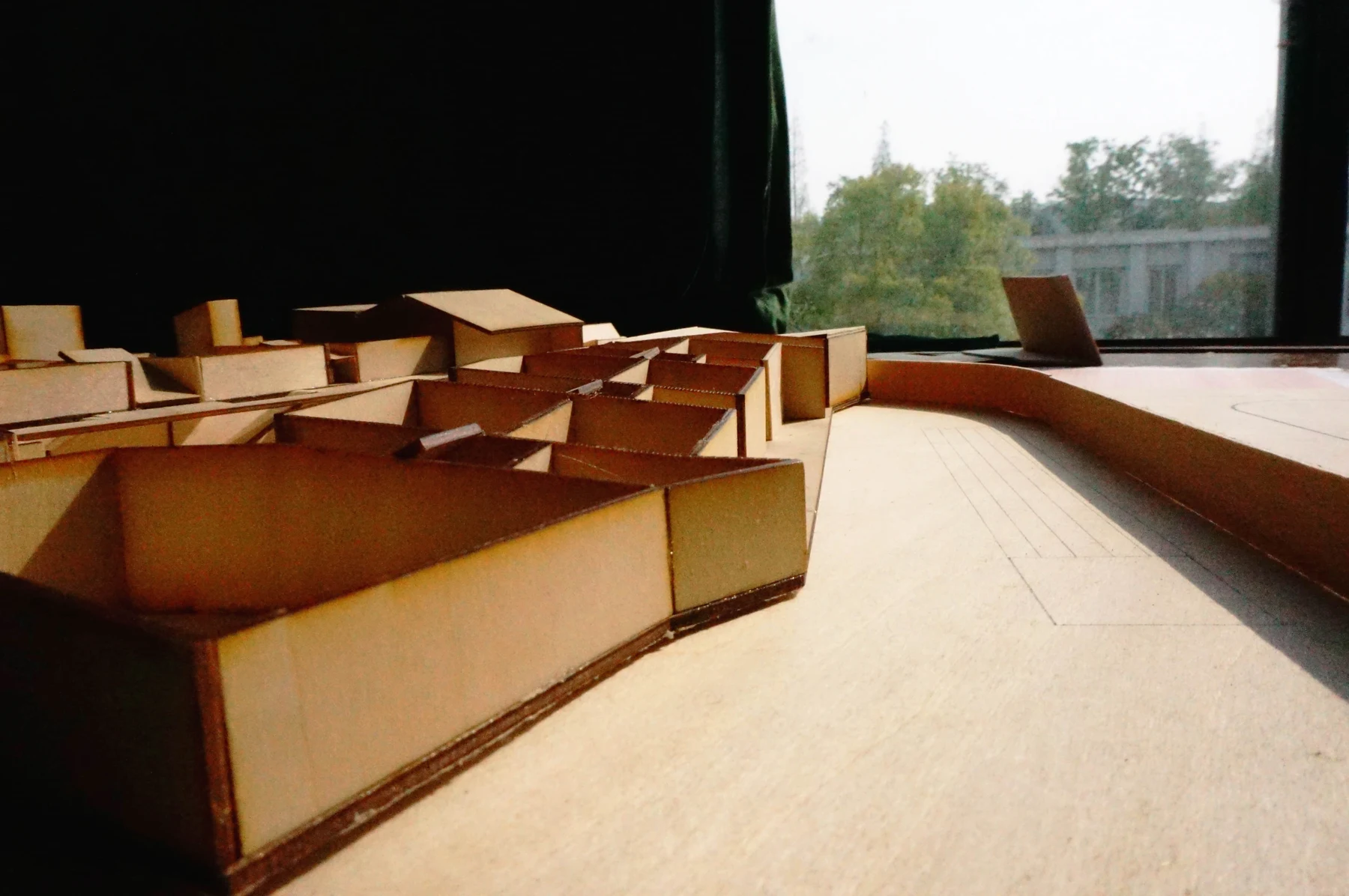 Close low-angle photograph looking along the open space beside the model walls